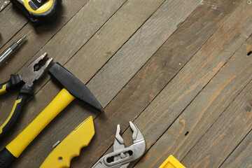 Repair tools, plumber, locksmith, electrician on a wooden background
