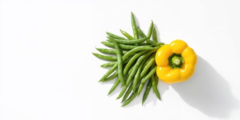 Green beans and yellow pepper arranged on a white background for fresh produce display, emphasizing colorful vegetables