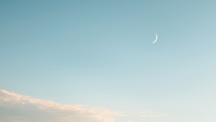 Crescent moon visible during daytime sky, emphasizing natural lunar visibility and daytime celestial phenomena