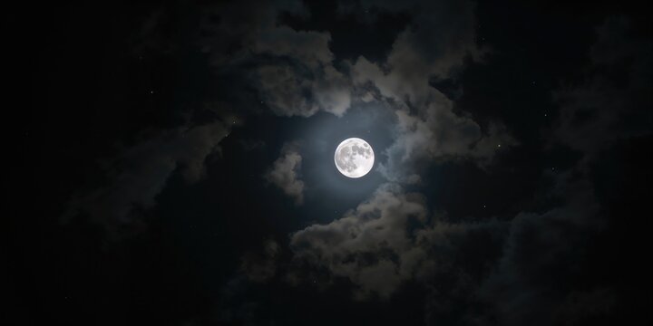 Fototapeta Full moon seen through cloud cover, atmospheric lighting for a nighttime scene, Earth Day