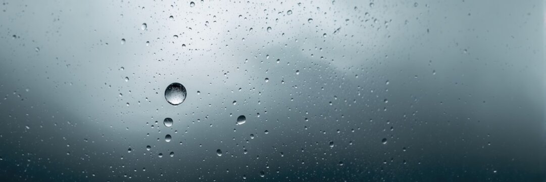 Gloomy sky and humid atmosphere, rain droplets on window for weather monitoring background - Powered by Adobe