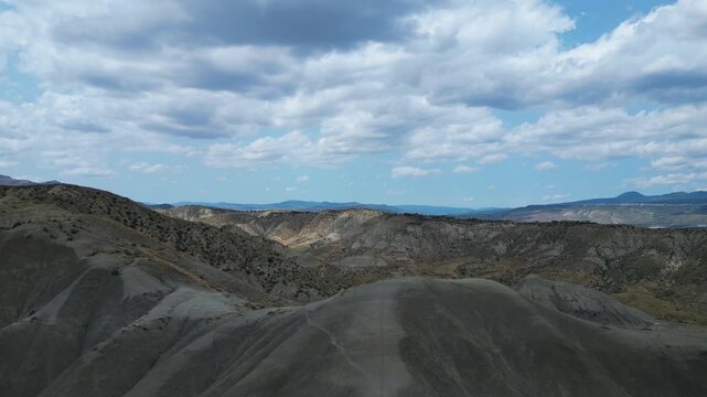 Aerial drone footage of the Centuripe desert-like landscape in Sicily: arid hills, warm tones and dramatic terrain. Ideal for cinematic, travel and nature stock projects.