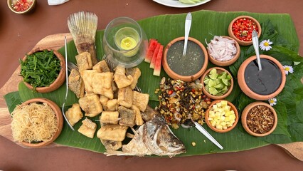 Deep-fried Sea bass wrap with fresh herbs, vegetable and Thai style sauce