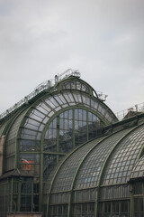 historic glasshouse architecture with arched windows and metal framework