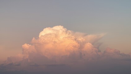 Cumulus cloud reflecting evening sunlight, serving as a background for weather patterns and atmospheric studies