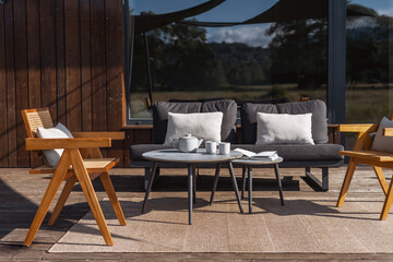 Modern wooden terrace with stylish furniture for outdoor relaxation and coffee time