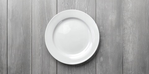 Empty white plate on table with food cooking background, suitable for health-focused layout or recipe presentation