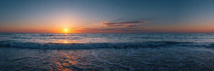 Obraz premium Sunrise over water with vibrant sky, ideal for background layouts and editorial headers, Earth Day