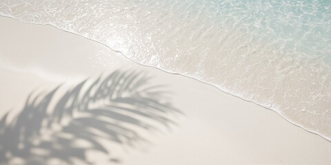 Palm leaf shadow on white sand beach with sunlight filtering through water waves, ideal for summer vacation background, Earth Day