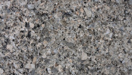 Closeup of black, white, and brown granite displaying natural patterns, suitable for background use in design projects