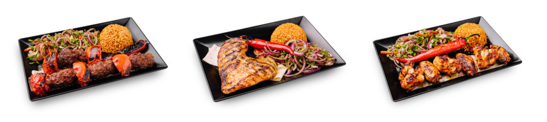 Delicious grilled meats served on black plates with colorful sides