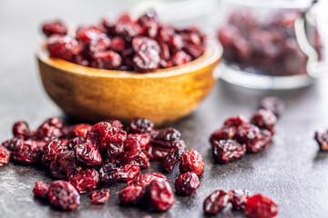 Tasty dried cranberries on black table.