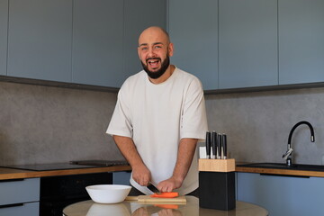 Man expressing frustration while preparing food in the kitchen, raising his voice during an emotional moment in everyday home life