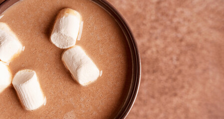 Close up top view of texture of cozy hot chocolate or homemade delicious cocoa drink decorated with...
