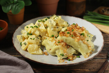 Traditional Swabian dish Maultaschen served with roasted onion and potato salad