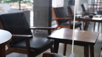 Serene Cafe Interior: Armchairs and Tables Through the Glass