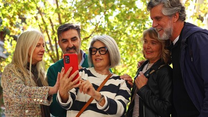Senior friends smiling taking selfie with smartphone
