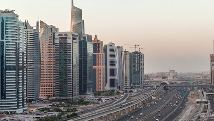 Aerial top view to Sheikh Zayed road near Dubai Marina and JLT night to day timelapse, Dubai.