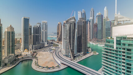 Fototapeta premium Aerial view of Dubai Marina residential and office skyscrapers with waterfront timelapse