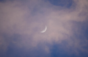Crescent Moon in Daytime Sky with Pink Clouds © Eolyn Visuals