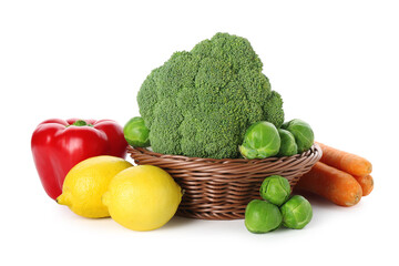 Different fresh raw vegetables and lemons isolated on white