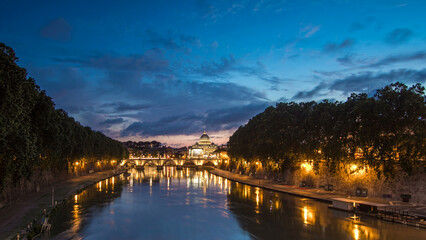 Obraz premium St. Peter's Basilica, Saint Angelo Bridge and Tiber River after the sunset day to night timelapse