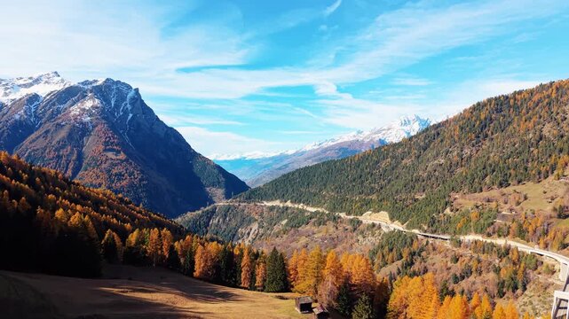Aerial view of the majestic Ganter Bridge cutting through the landscape, with mountains, and autumnal trees, creating a stunning vista, Ried-Brig, Wallis, Switzerland.