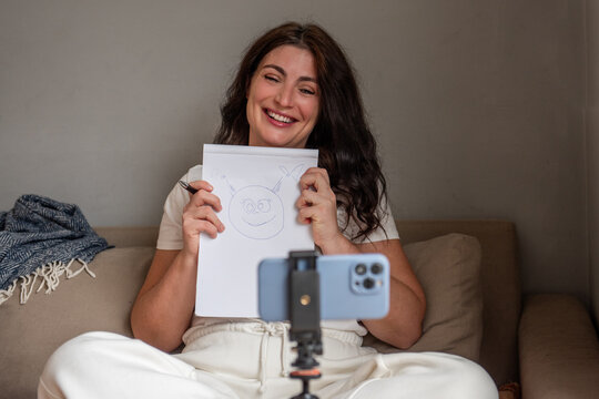 Woman streaming from home with smartphone