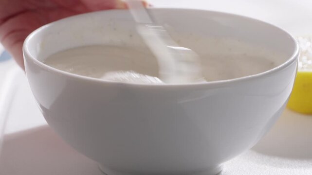 Homemade dip made from Greek yogurt mixed with garlic powder, spices, lemon juice, and olive oil. High quality 4k footage