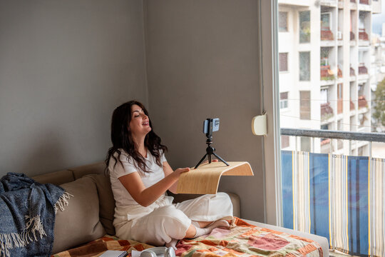 Woman streaming at home with smartphone