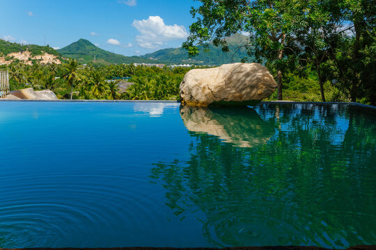 Tranquil infinity pool overlooking lush Nha Trang landscape