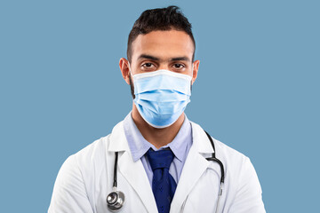 A healthcare worker is depicted with a face mask and stethoscope, ready to assist patients in a clinical environment. The focus is on providing care and safety.