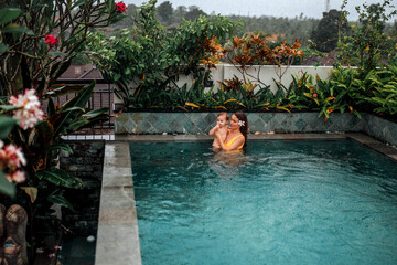 Relaxing poolside with family in Bali's paradise