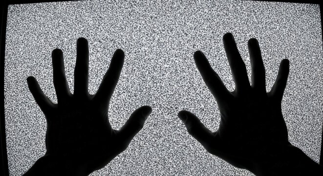 Eerie silhouetted hands pressing against a vintage television screen displaying a chaotic static - Powered by Adobe