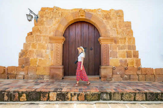 Woman exploring historic architecture in Barichara