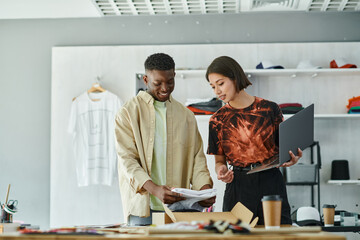 Young entrepreneurs collaborating in a vibrant print studio with diverse creativity