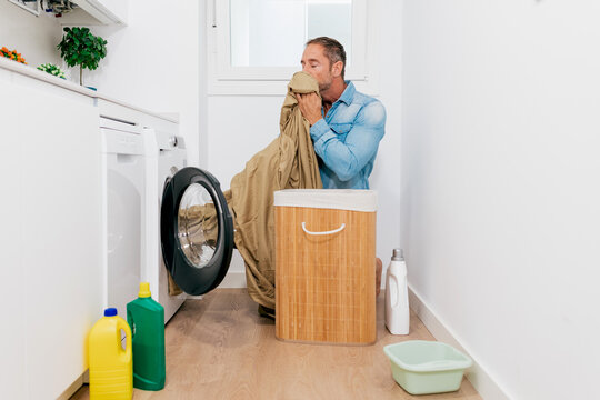 Man doing laundry in a modern home setting