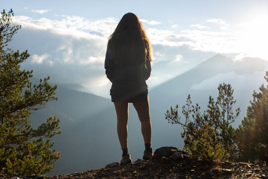 Woman enjoying a sunset in the Pyrenees landscape