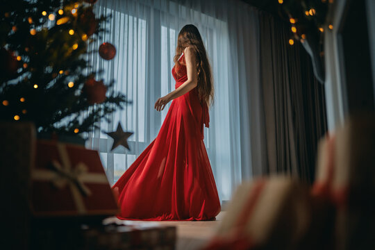 woman near Christmas tree indoor
