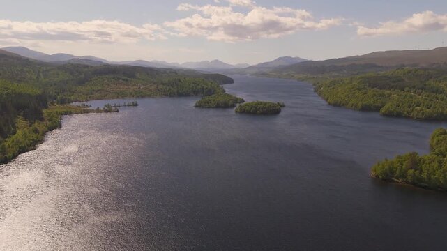 drone flight over Loch Garry reservoir in the Highlands of Scotland with smooth motion and wind on the surface of the water 