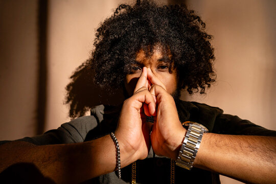 Pensive man in studio with afro hairstyle