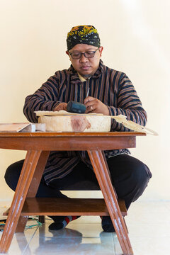 Javanese artisan crafting traditional wayang kulit puppets