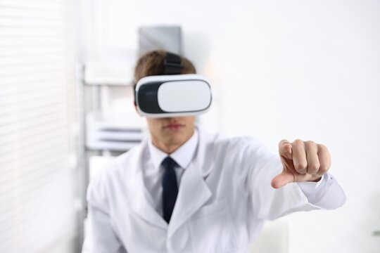 Modern technology. Doctor using virtual reality headset indoors, selective focus