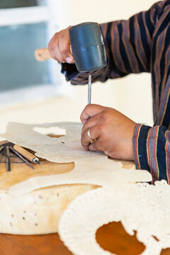 Crafting traditional wayang kulit shadow puppets