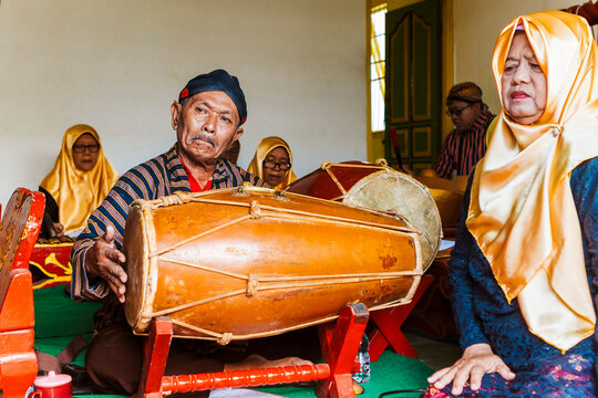 Traditional Javanese gamelan musicians playing instruments
