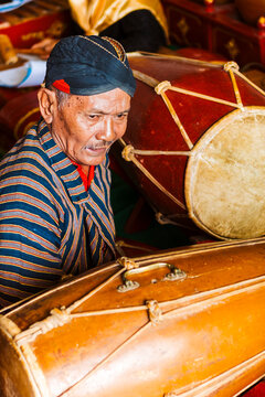 Traditional Javanese gamelan musician playing drum