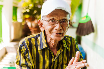 Elderly man enjoying traditional music in Java