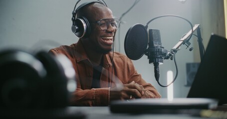 Voice Actor Records Professional Dubbing For Film or Media Project. Man at Laptop Recording Audio...