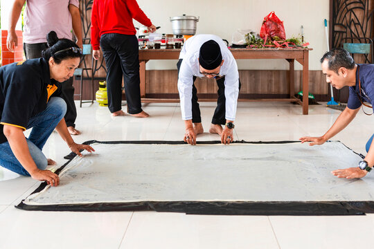 Indonesian artisans creating traditional batik craft