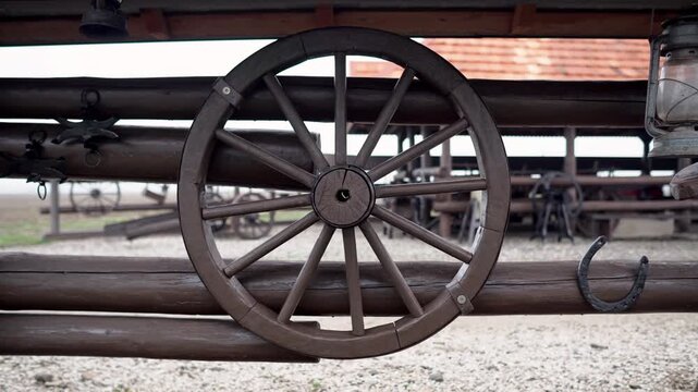 A wooden fence decorated with antique agricultural objects on a farm in Ukraine in Transcarpathia. Buffalo farm in rural Ukraine. Authentic agriculture, livestock and rural lifestyle